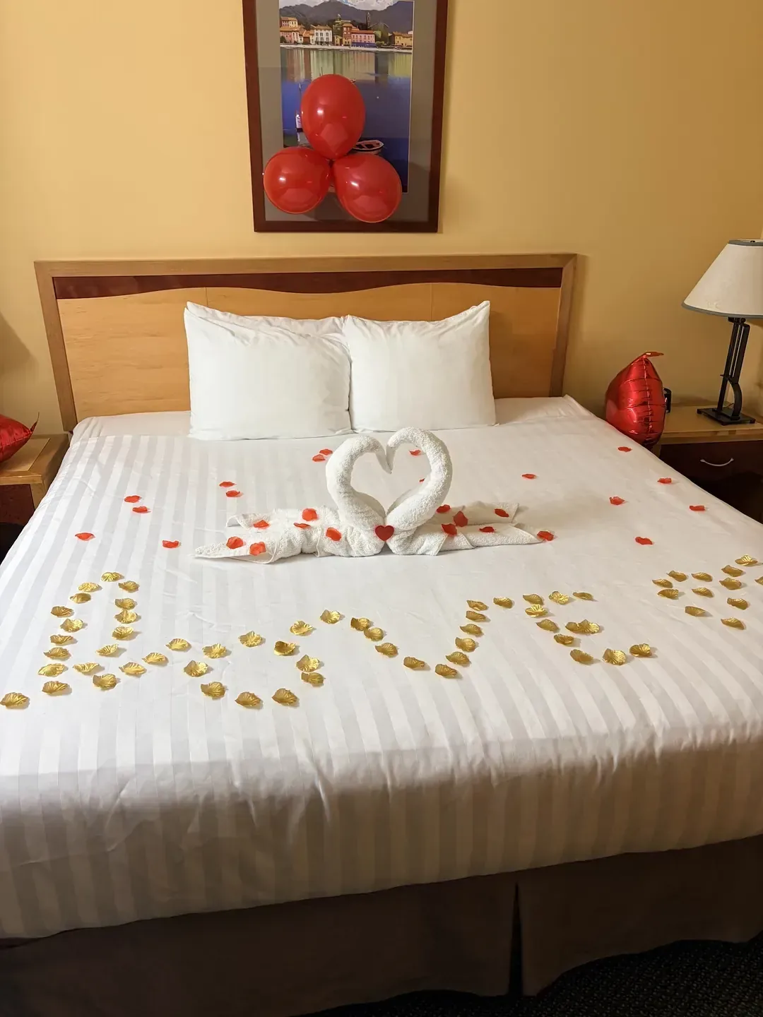Guest bed dressed with towel swans at Medicine Hat Lodge, Medicine Hat